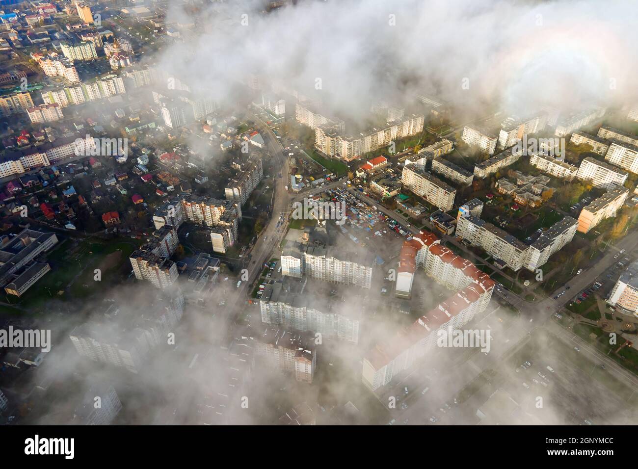 Top aerial view of fluffy white clouds over modern city with high rise ...