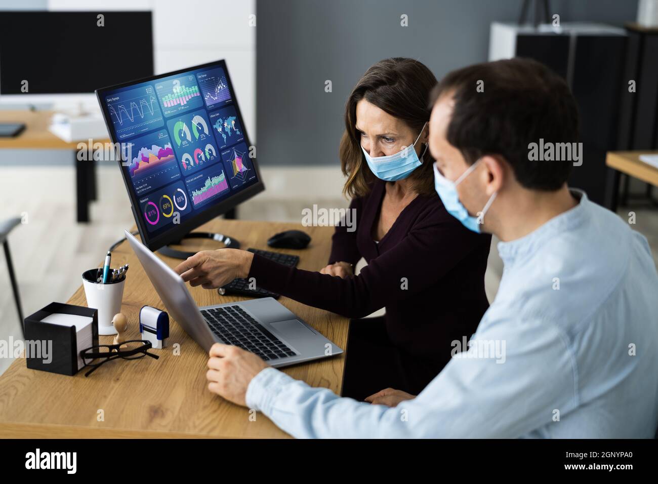 Manager Training Business People At Computer In Face Mask Stock Photo
