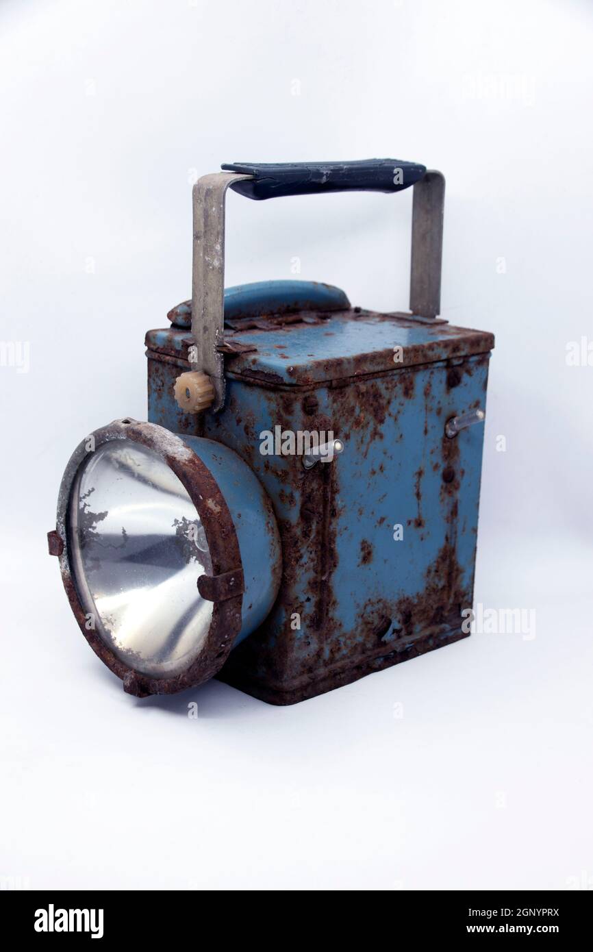 Old rusty blue railway lantern on white background. Stock Photo
