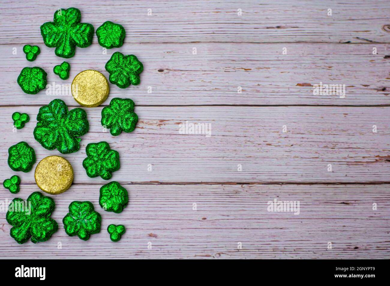 Glitter Covered Four Leaf Clovers and Coins Filling One Half of the ...