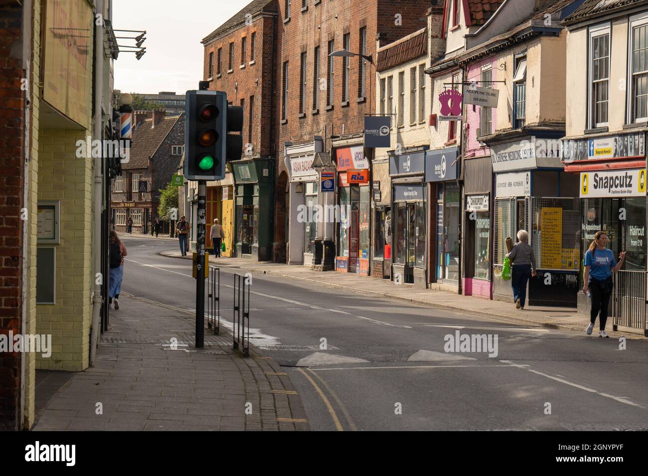 A view looking up Magdalen Street Norwich with people walking along the