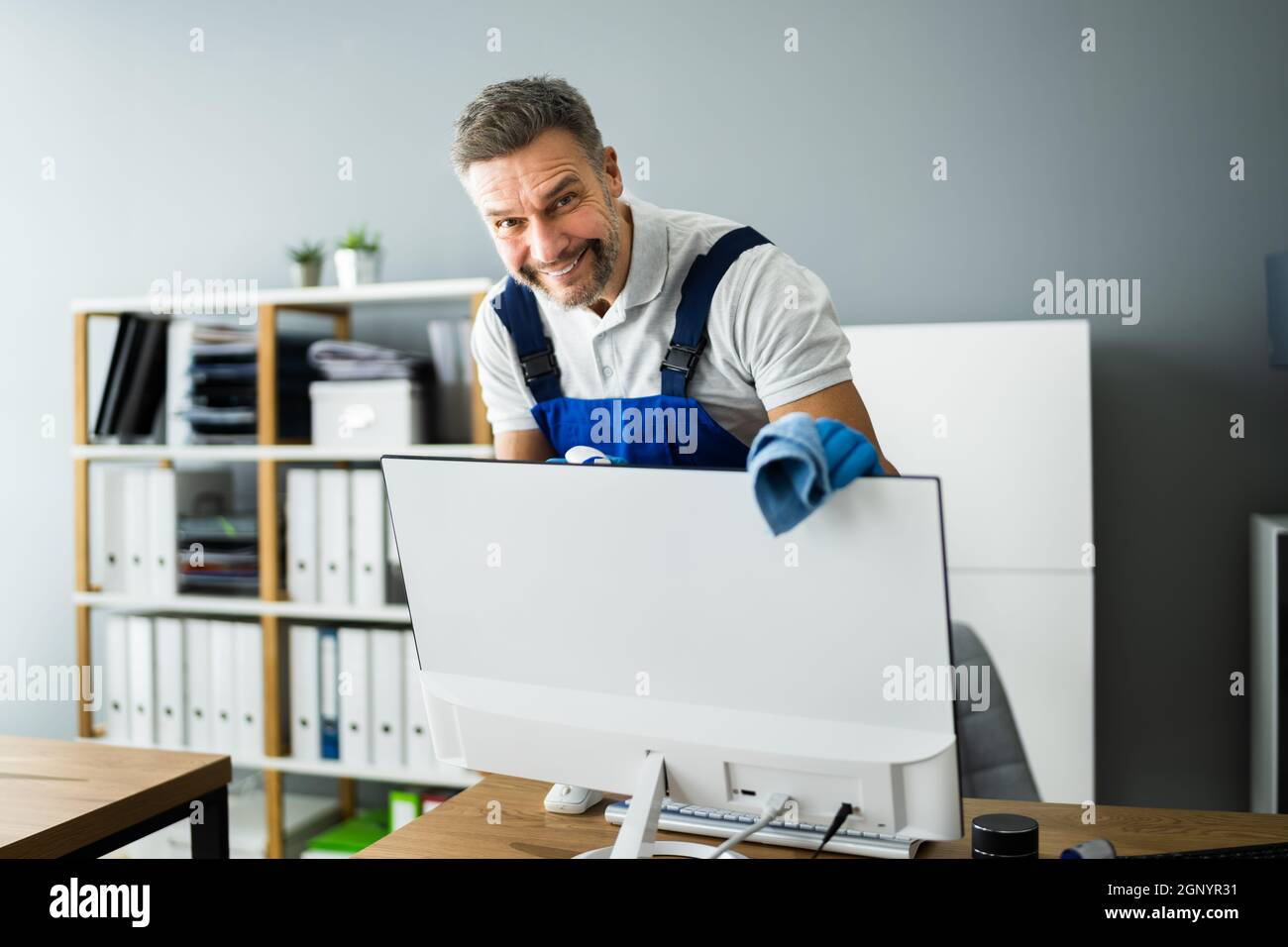 Professional Office Cleaning Janitor Service. Monitor At Desk Stock