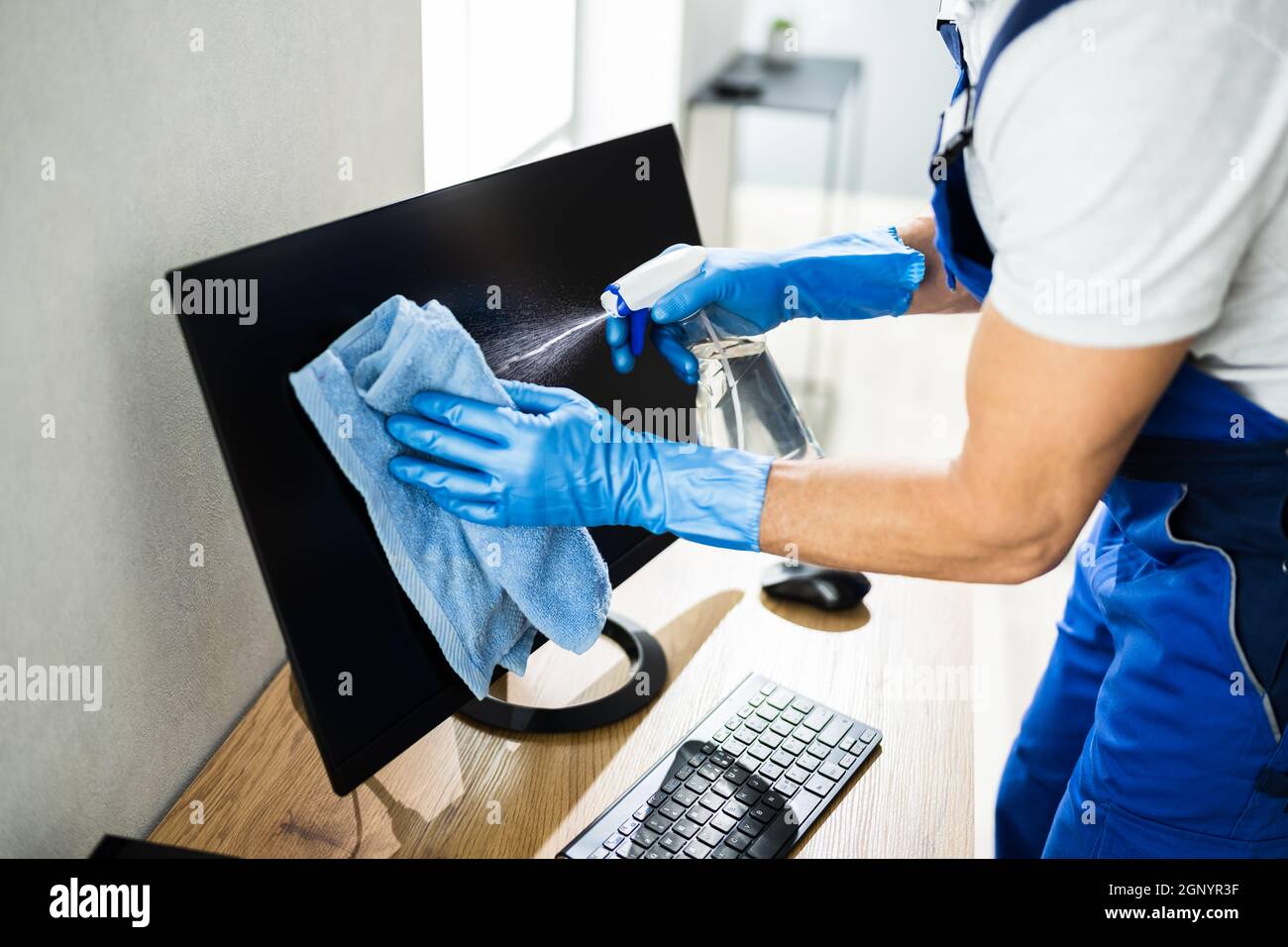 Professional Office Cleaning Janitor Service. Monitor At Desk Stock