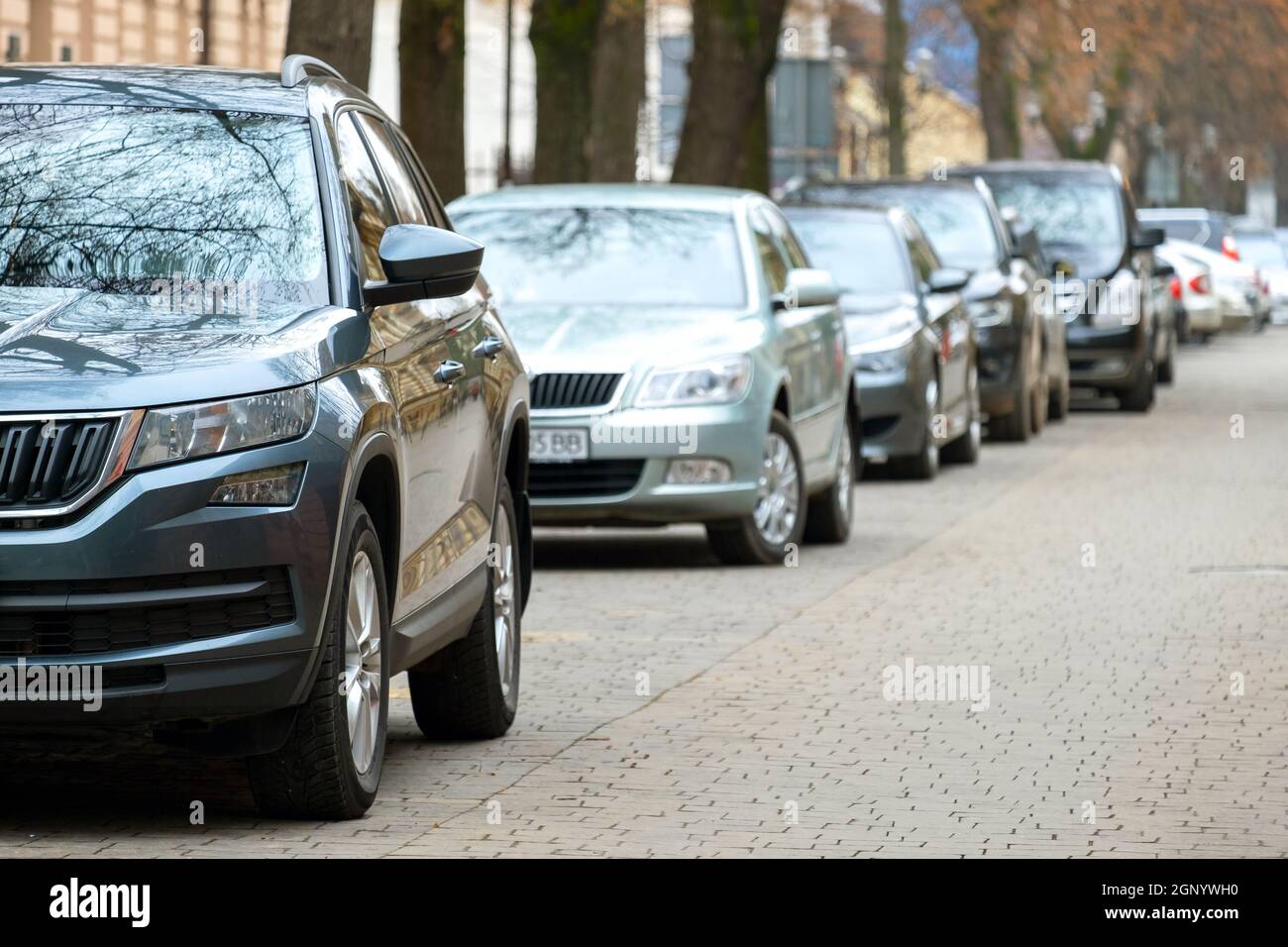 Cars parked in a row on a city street side Stock Photo - Alamy