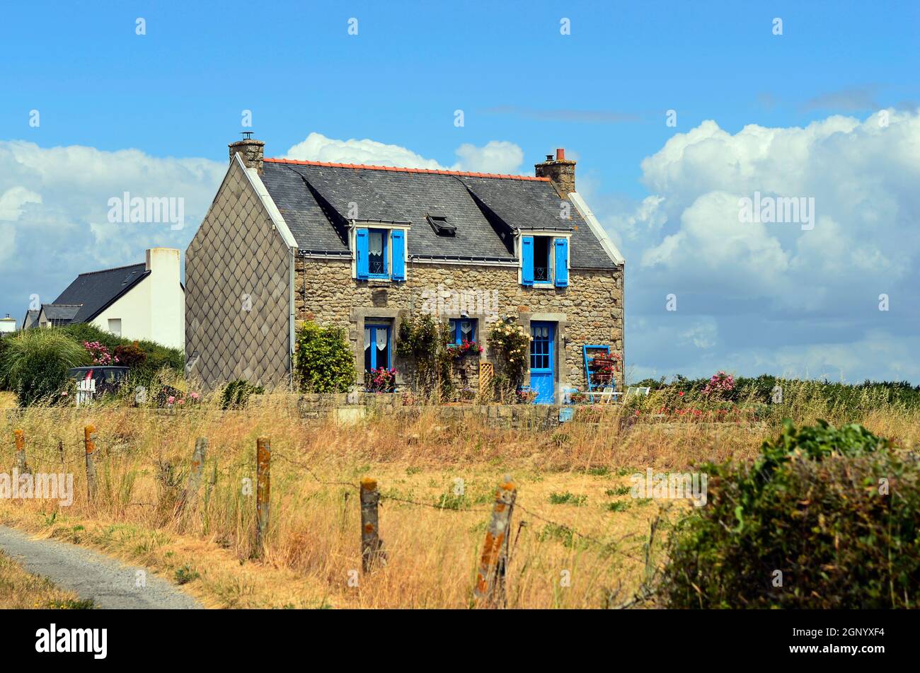 France, Carnac, stone built home with colorful windows Stock Photo