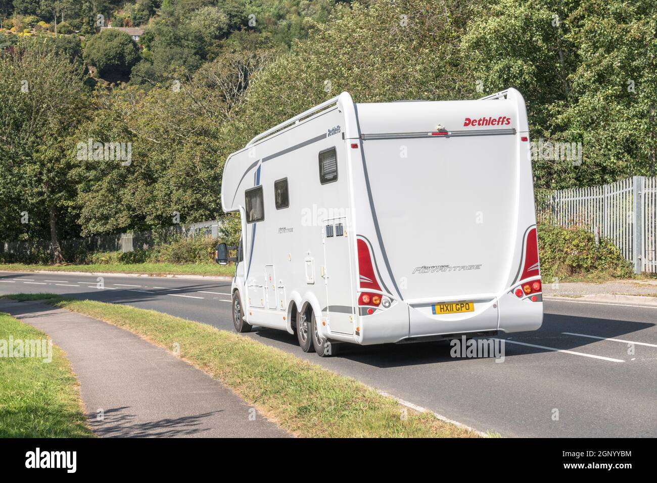 Arist Dethleffs motorhome travelling downhill on country road in Cornwall. For UK motorhomes, campervans, staycations in UK, alternative holidays. Stock Photo