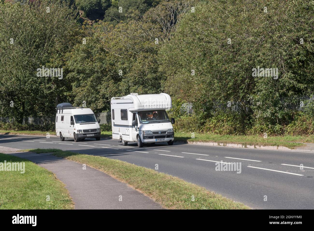 Auto-Trail Apache SE motorhome travelling uphill on a country road in Cornwall. For UK motorhomes, campervans, and staycations in the UK. Copy space. Stock Photo