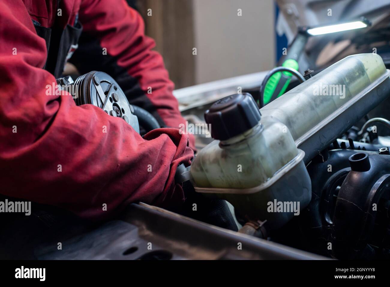 Mechanic hand at work on the engine in the workshop Stock Photo - Alamy