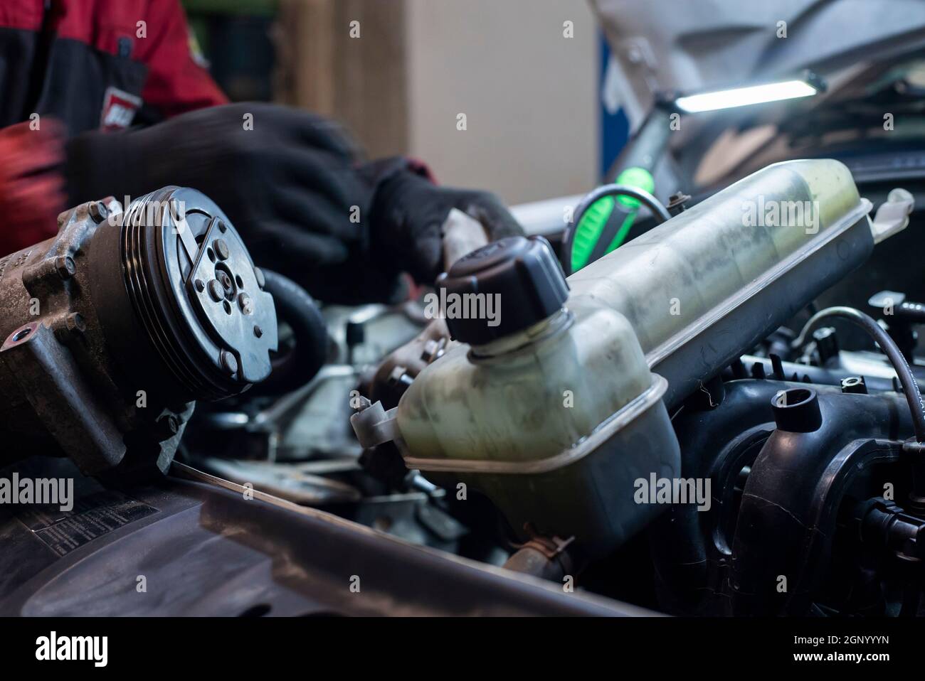 Mechanic hand at work on the engine in the workshop Stock Photo - Alamy