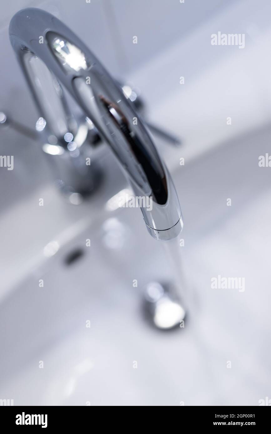 Close up of a water spigot in a clean bathroom. Water saving. Stock Photo