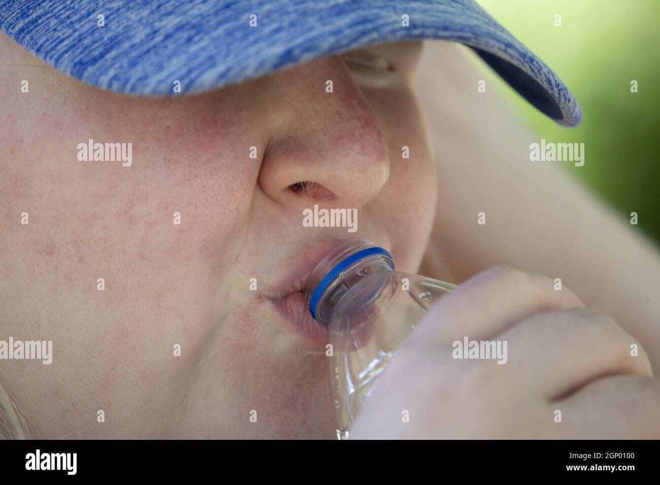 Woman drinking from a plastic, disposable water bottle Stock Photo - Alamy