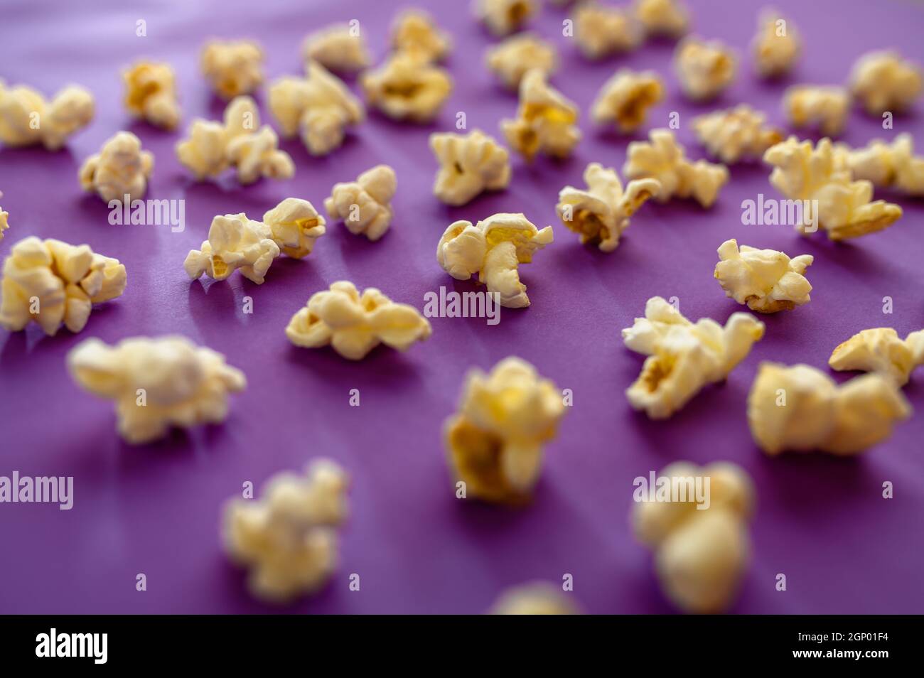 Popcorn pattern closeup isolated on purple background. Pop corn texture