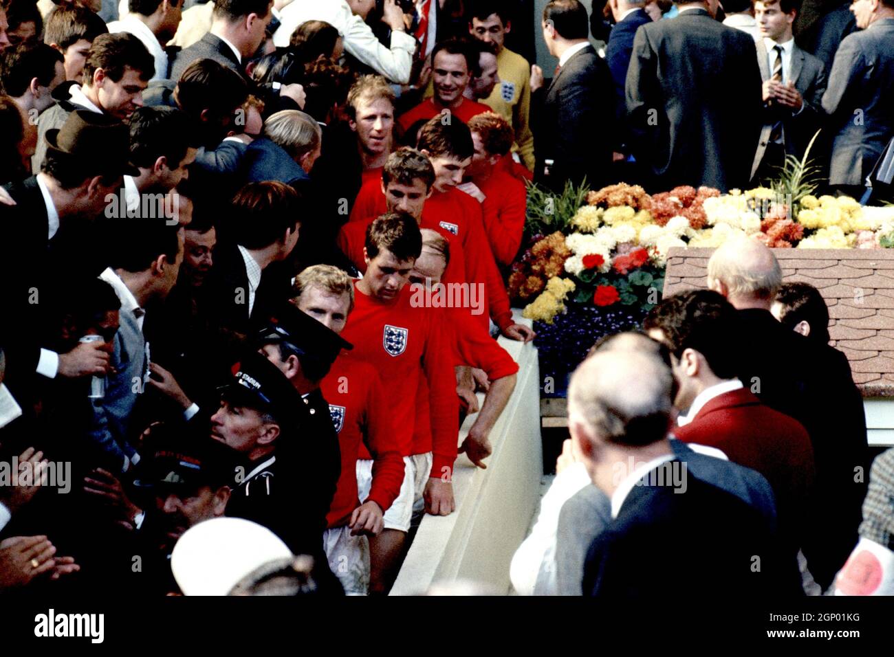 File photo dated 30-07-1966 of The victorious England players walk down the steps from the Royal Box after being presented with the World Cup: (bottom to top) Bobby Moore, Geoff Hurst, Bobby Charlton, Roger Hunt, Martin Peters, Ray Wilson (hidden), Alan Ball, Jack Charlton, George Cohen, Nobby Stiles and Gordon Banks Issue date: Tuesday September 28, 2021. Stock Photo