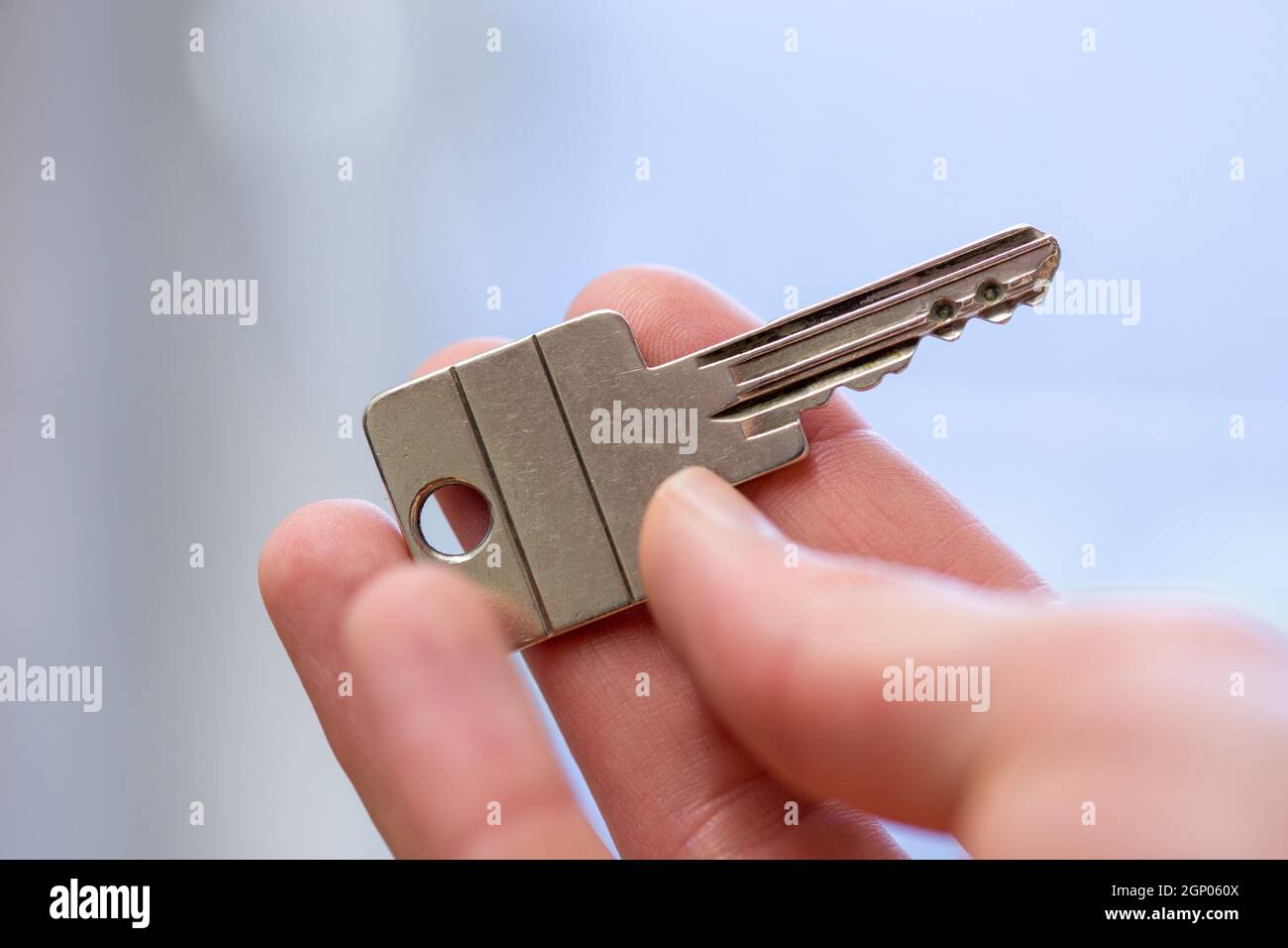 Holding a house key in the hand New home and property Stock Photo Alamy