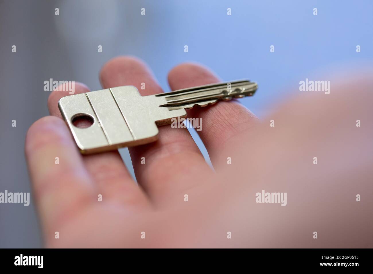 Holding a house key in the hand New home and property Stock Photo Alamy