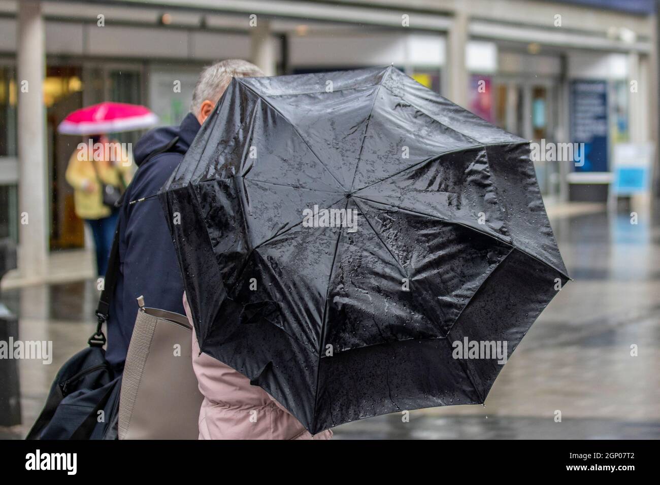 Southport, Merseyside, UK Weather; 28 Sept 2021.  Shops, shoppers shopping on a wet windy, blustry day in the north-west town centre.  Credit: MediaWorldImages/AlamyLiveNews Stock Photo