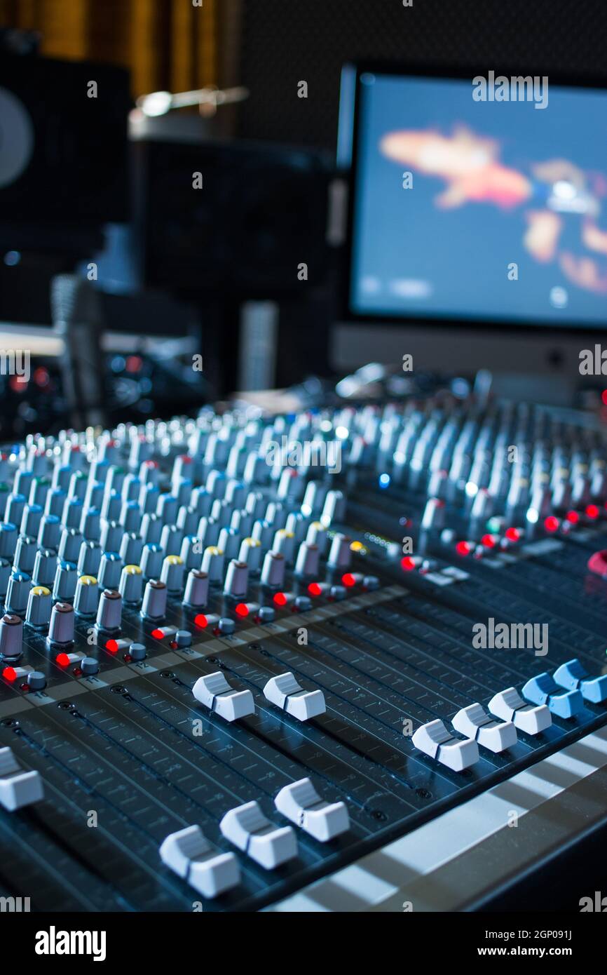 Professional music production in a sound recording studio, mixer desk ...
