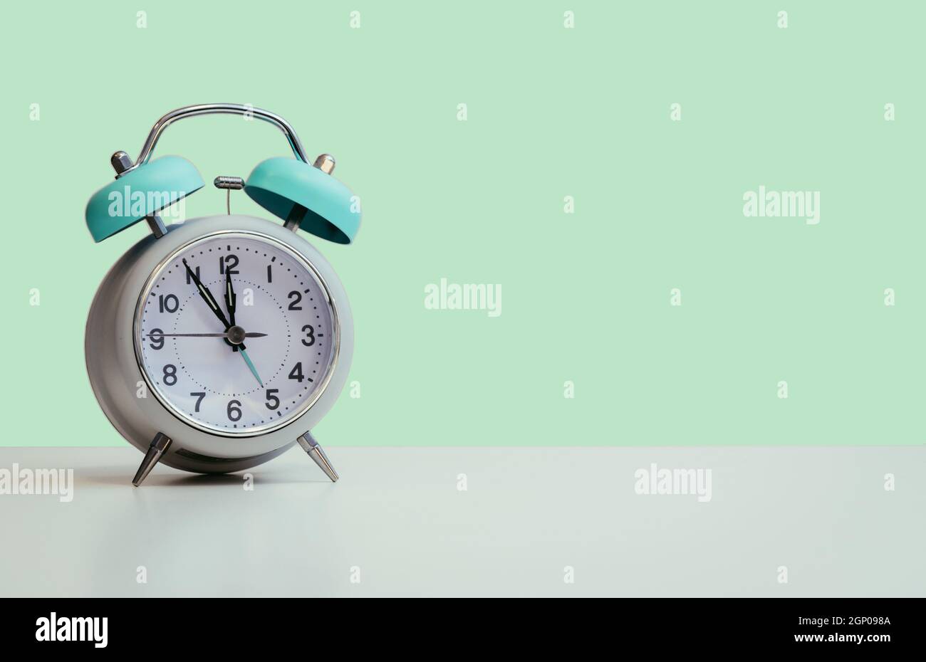 Retro styled white alarm clock, isolated and copy space, green Stock Photo