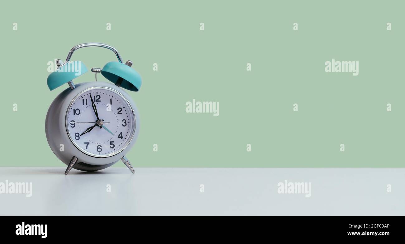 Retro styled white alarm clock, isolated and copy space, green Stock Photo