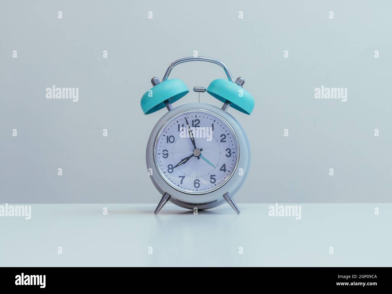 Retro styled white alarm clock, isolated and copy space Stock Photo