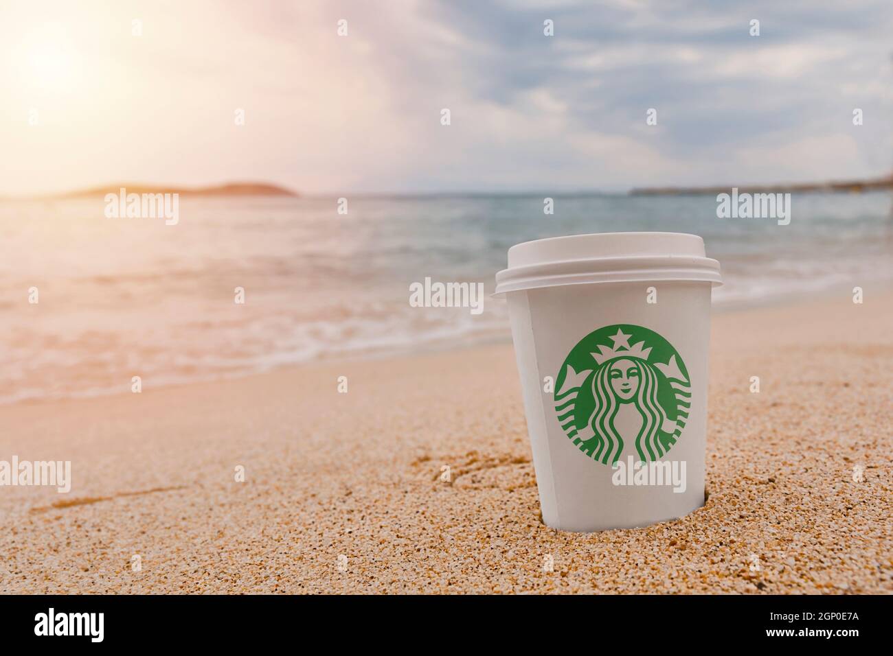 https://c8.alamy.com/comp/2GP0E7A/thassos-greece-august-21-2018-starbucks-paper-cup-of-coffee-on-the-sea-water-and-beach-sandy-background-2GP0E7A.jpg