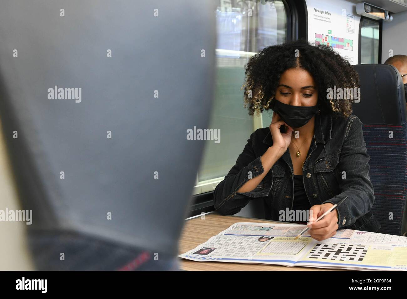 EDITORIAL USE ONLY Danniella Evans onboard a train as new research, conducted with University College London Neuroscientists as part of the rail industry's 'Let's get back on track' campaign, reveals that commuting by train offers psychological benefits for both wellbeing and brain function, London. Issue date: Tuesday September 28, 2021. Stock Photo