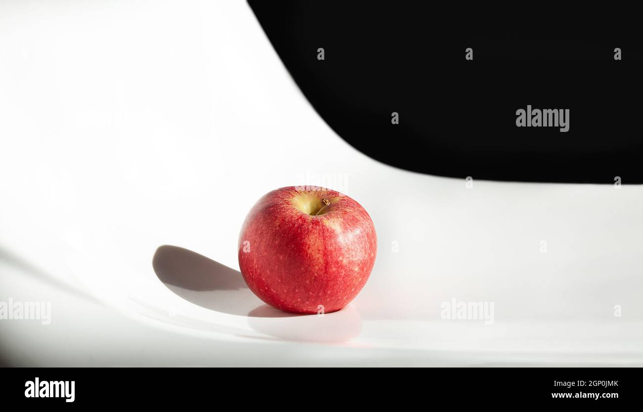 Red apple on black and white background. Stock Photo