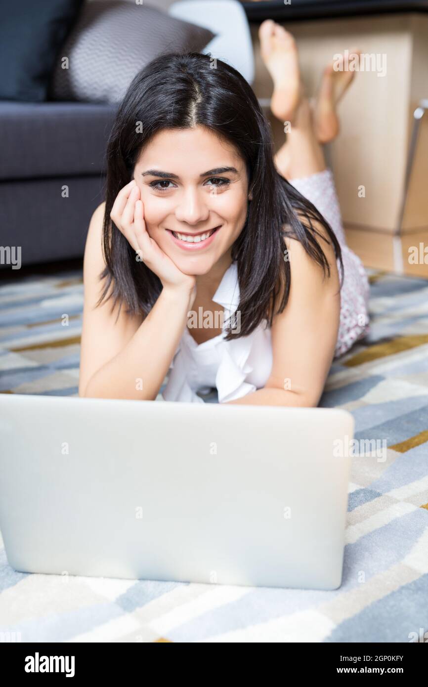 Beautiful woman relaxing with a computer Stock Photo - Alamy