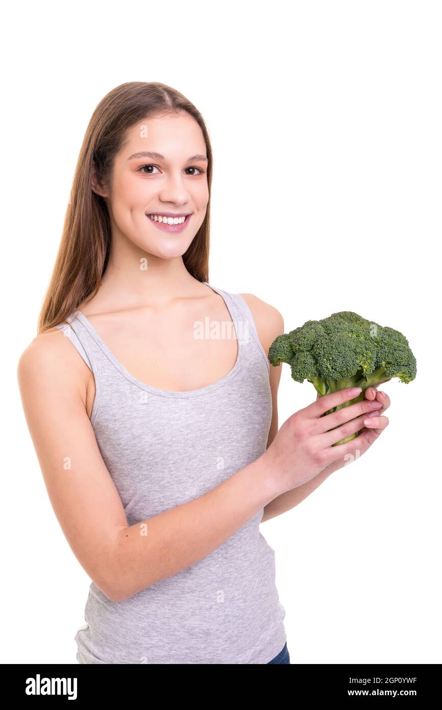 How to cook broccoli? Beautiful young woman holding broccoli and while