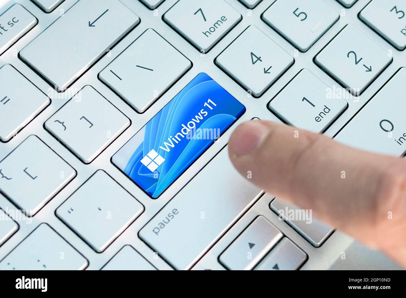 June 23, 2021. Barnaul, Russia. Close up of finger on keyboard button with Windows 11 logo A new operating system update from Microsoft Stock Photo
