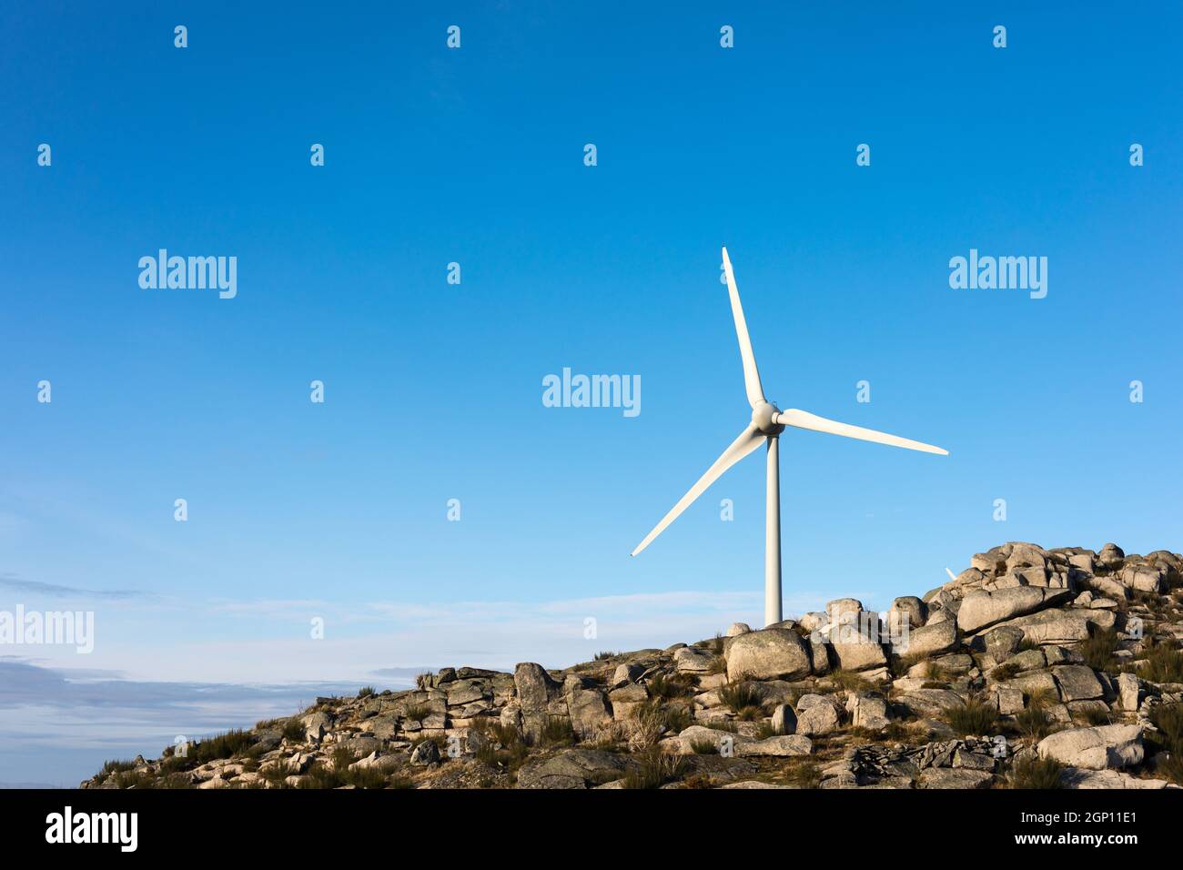 Wind energy turbines, in a landscpae over a beautiful blue sky Stock ...