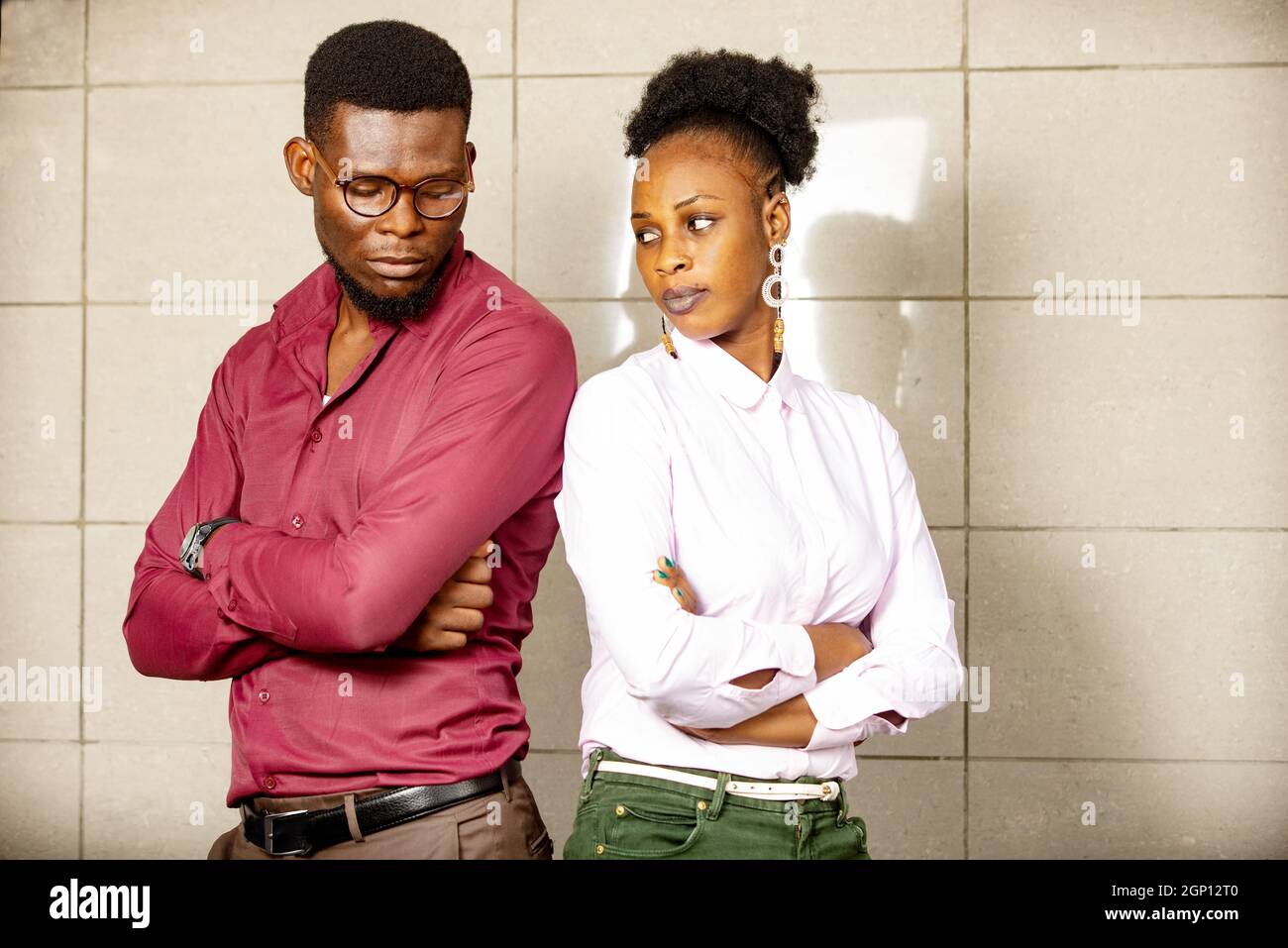 portrait of a young african couple, man and woman standing back to back ...