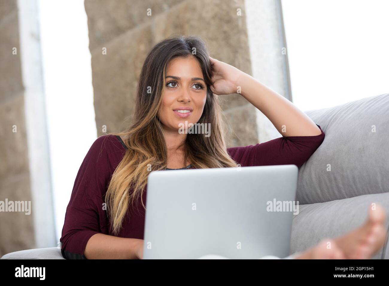 Beautiful young woman relaxing at home on her laptop computer Stock ...