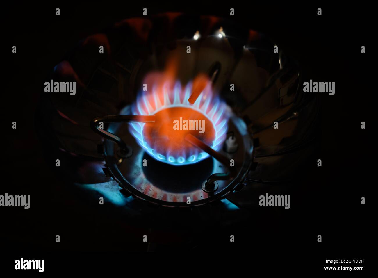 Blue flame gas stove in the dark. Selective focus with shallow depth of field. Stock Photo