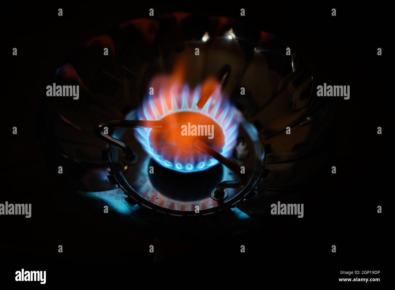 Blue flame gas stove in the dark. Selective focus with shallow depth of