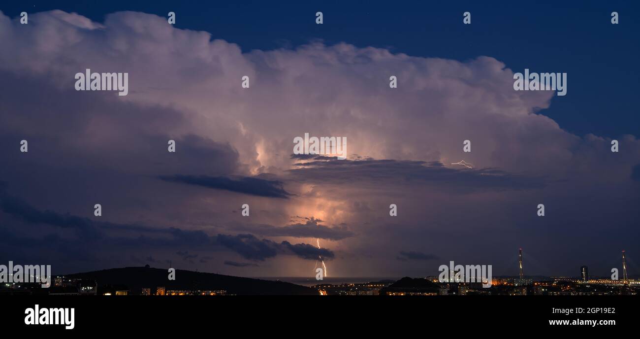 Lightning storm at night over city Stock Photo - Alamy