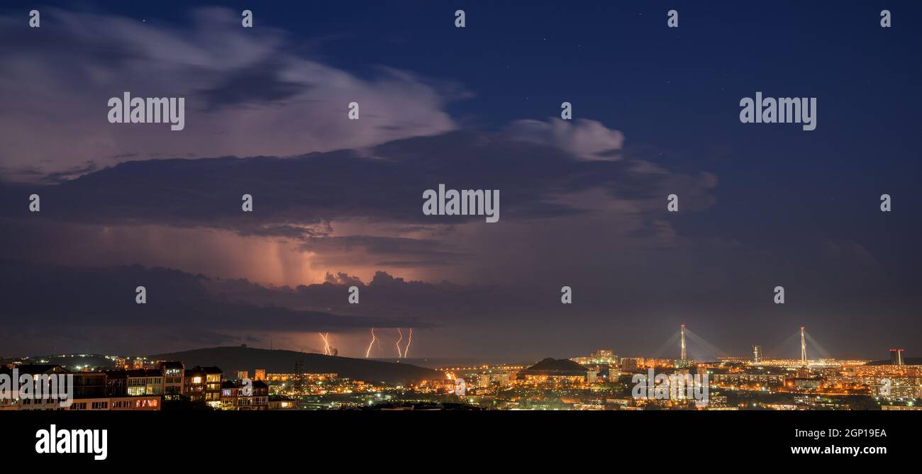 Lightning storm at night over city Stock Photo - Alamy