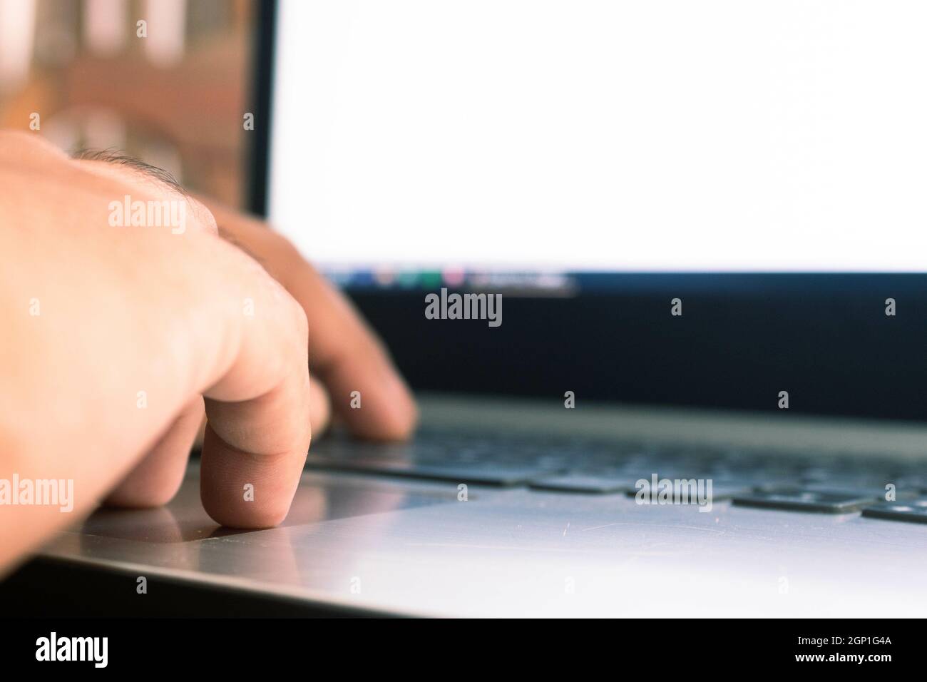Close-up of a hands of a young typing on the keyboard, working online on a laptop computer Stock Photo