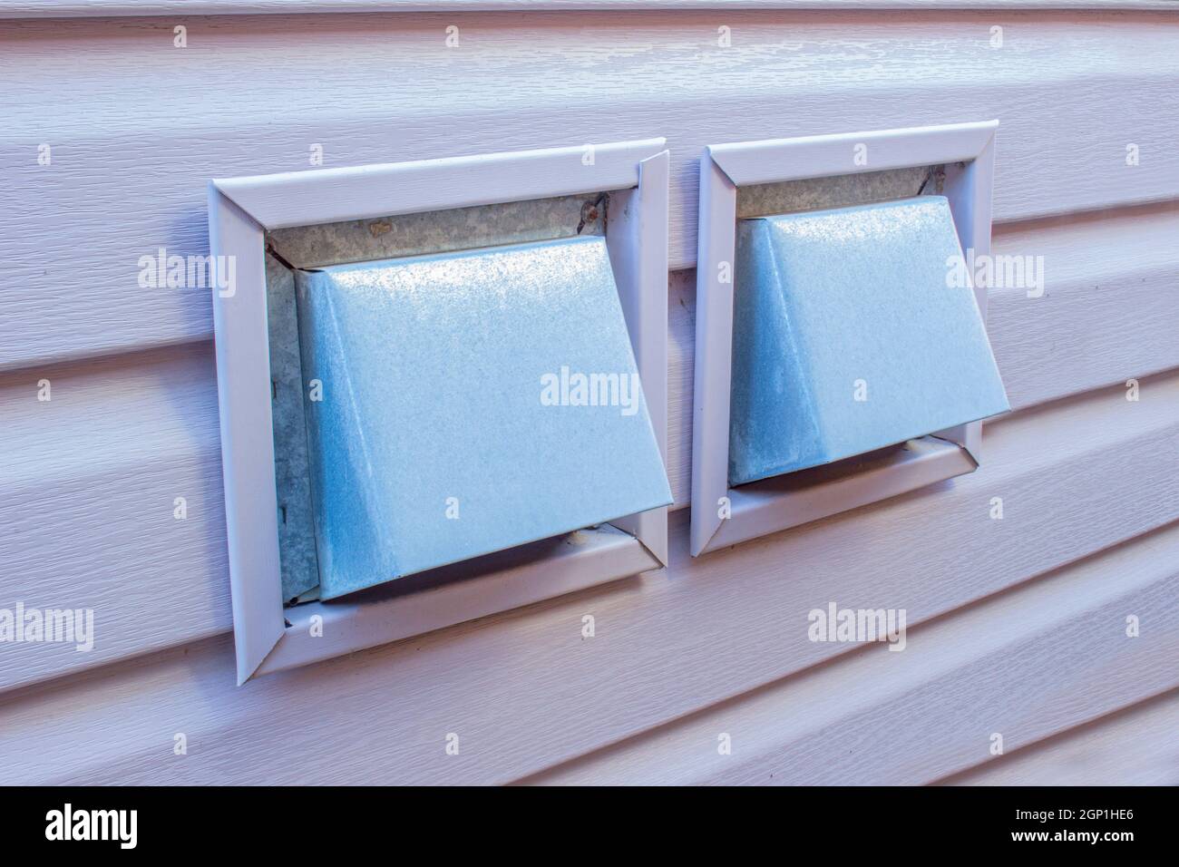 Side view of an Air Wall Cap. Vent cap outside building. Furnace duct