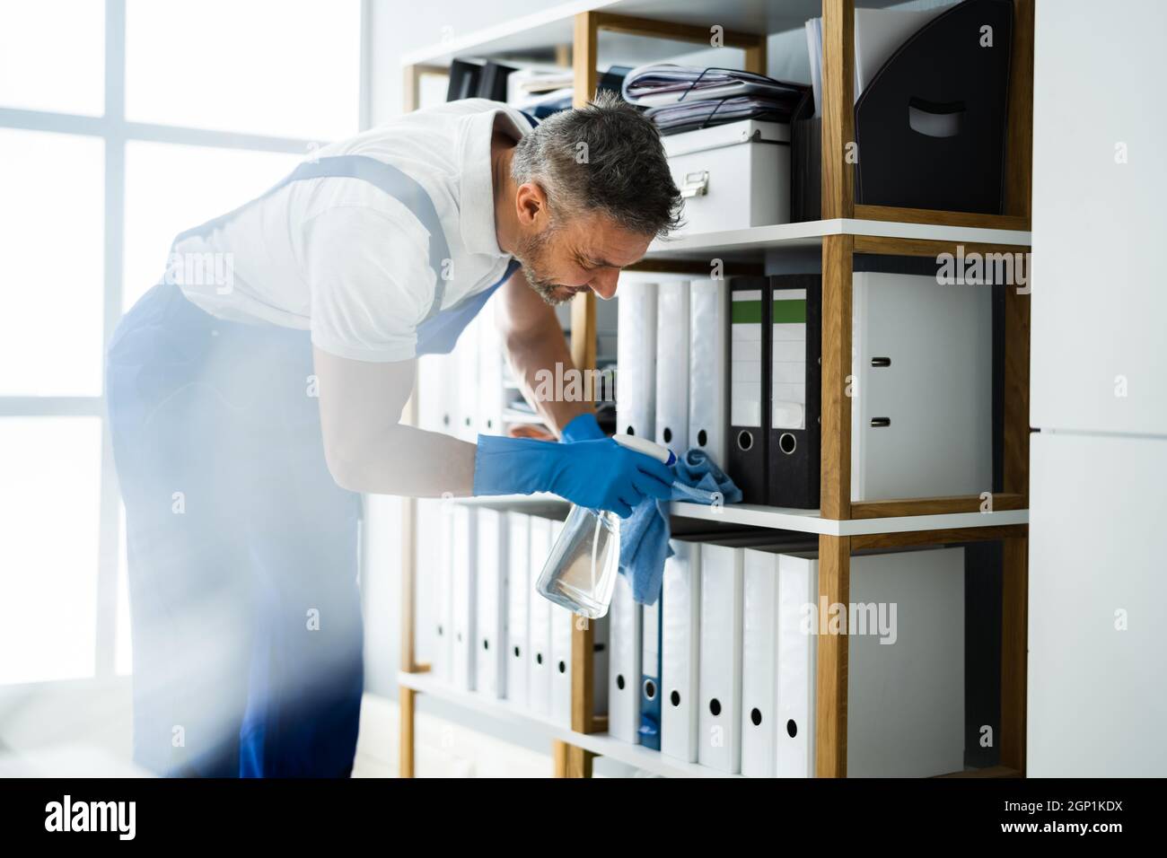 Professional Janitor Office Cleaning Service. Man With Chemical Spray