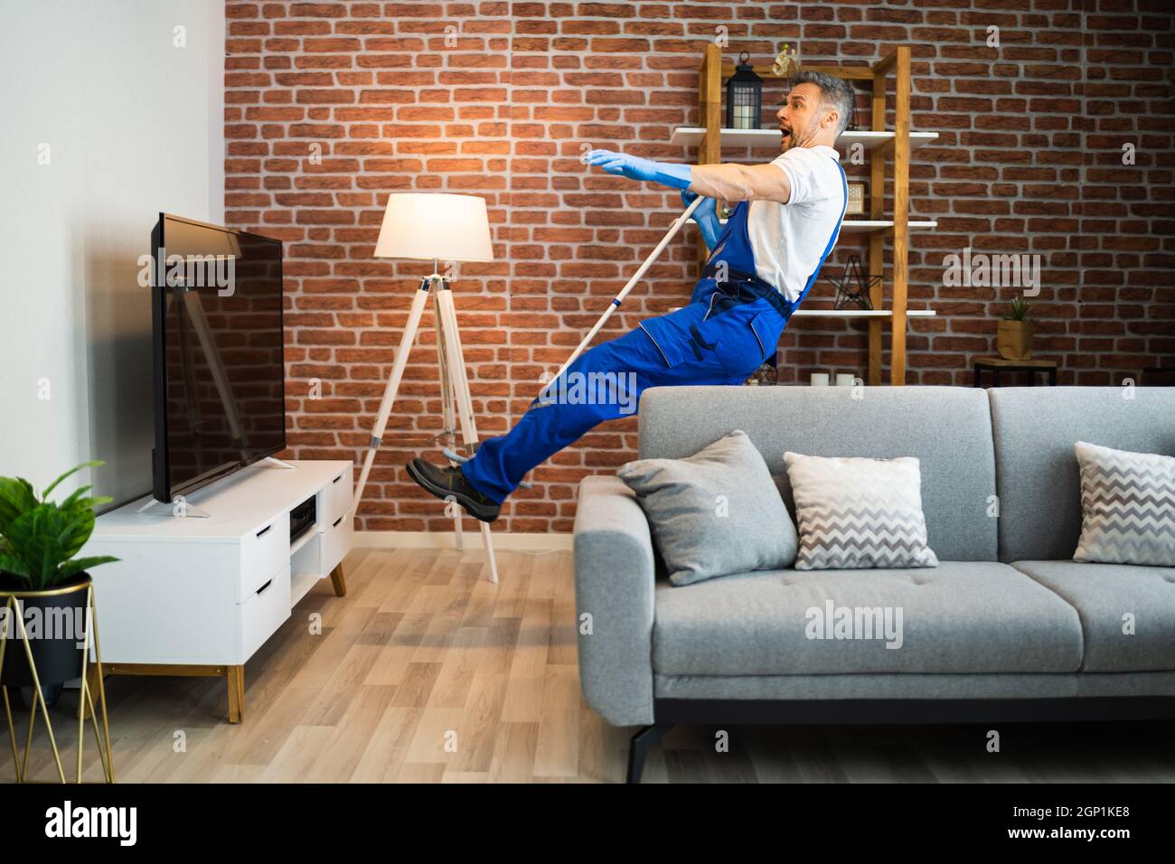 Domestic Slip And Fall Accident At Home. Falling Janitor Stock Photo