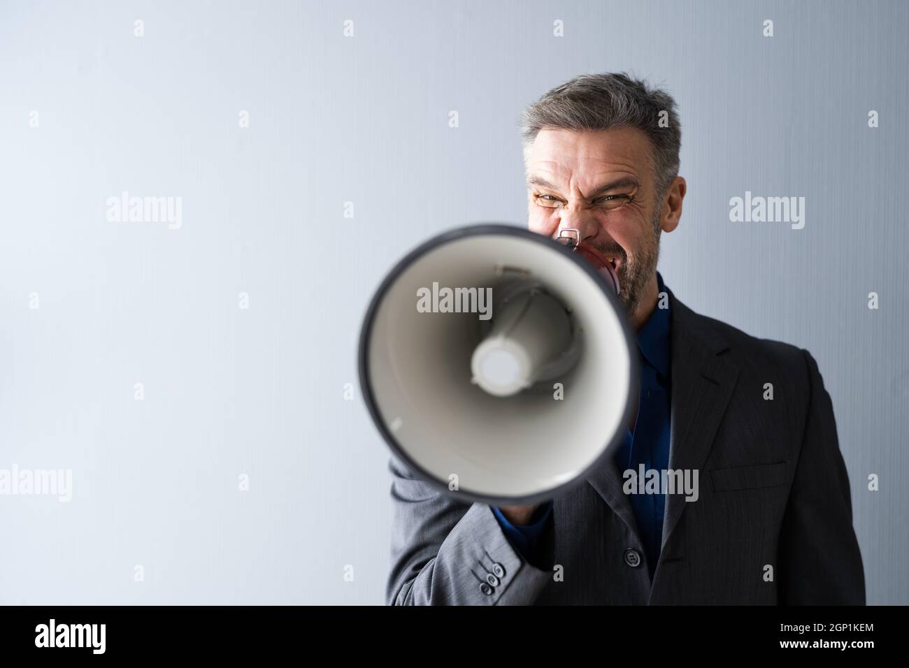Man Making Megaphone Announcement. Warning Concept Speaker Stock Photo