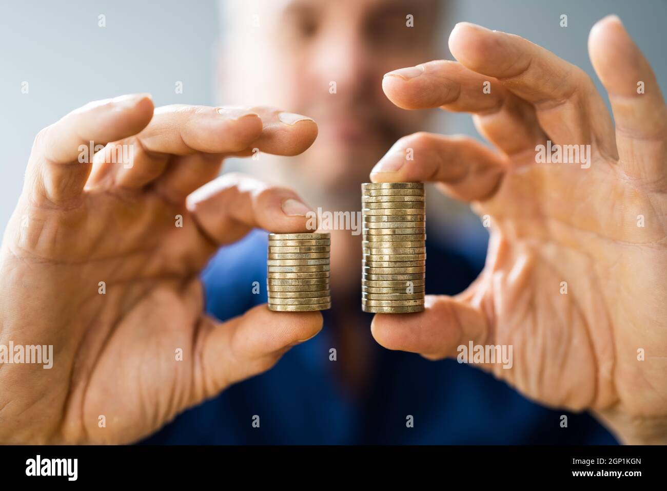 Money Disparity And Pay Gap. Comparing Tax And Salary Stock Photo