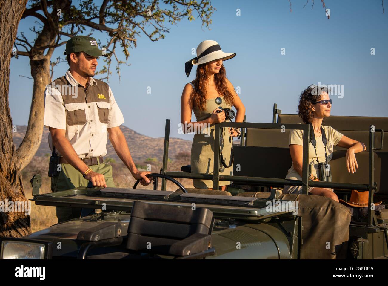Guide and two female guests in jeep Stock Photo