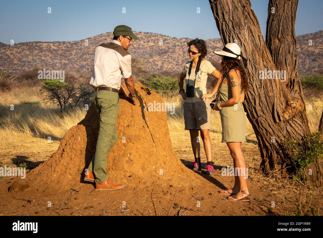 Guide explains termite mound bloodstain to women Stock Photo