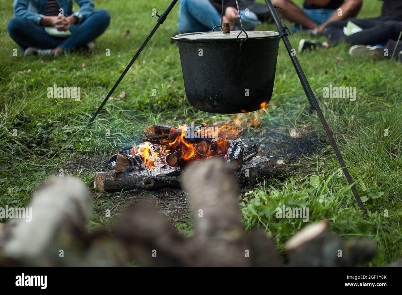 Dark big pot or cauldron, cooking pan with boiling water inside above the  fire somewhere in the park or mountains, camping concept Stock Photo by  ©balinska_lv 507313174