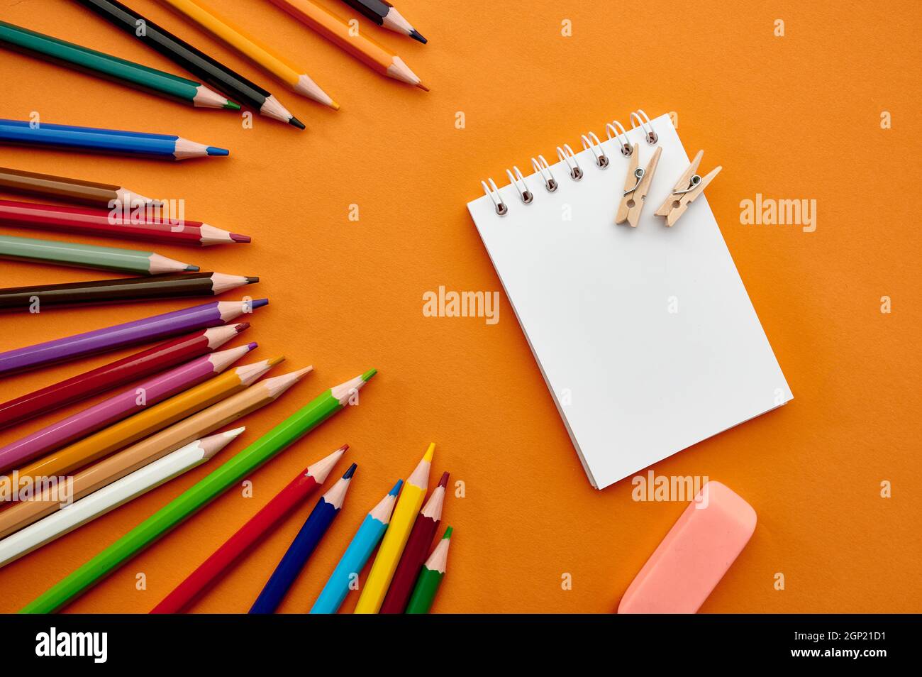 https://c8.alamy.com/comp/2GP21D1/set-of-colorful-pencils-and-notepad-orange-background-office-stationery-supplies-school-or-education-accessories-writing-and-drawing-tools-2GP21D1.jpg