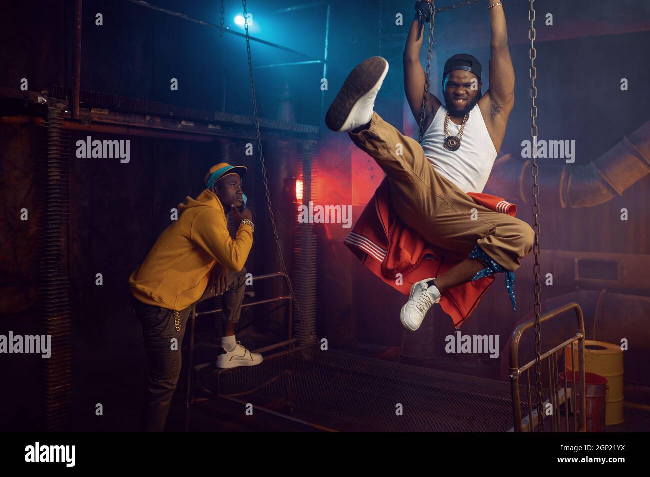 Two rappers joking, performing in cool studio, underground decoration ...