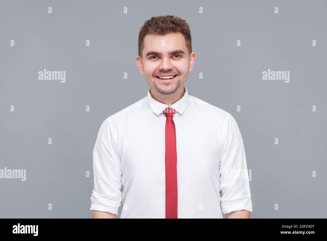 Portrait of young handsome happy successful man in white shirt and tie ...