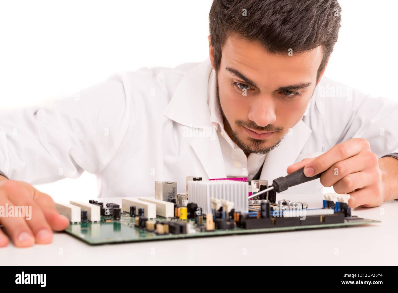 A computer engineer or technician, working on a computer motherboard ...
